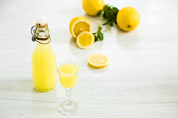 Image showing Italian traditional liqueur limoncello with lemon