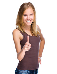 Image showing Woman is showing thumb up gesture