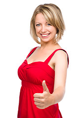 Image showing Woman is showing thumb up gesture