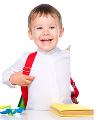 Image showing Little child playing school