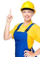 Image showing Young construction worker pointing up