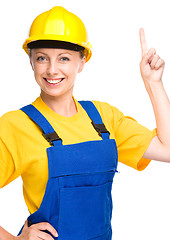 Image showing Young construction worker pointing up