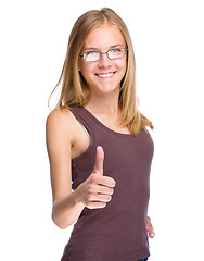 Image showing Young teen girl is showing thumb up gesture