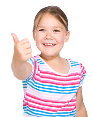 Image showing Little girl is showing thumb up gesture