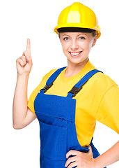 Image showing Young construction worker pointing up