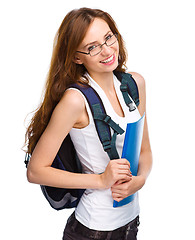 Image showing Young student girl is holding book