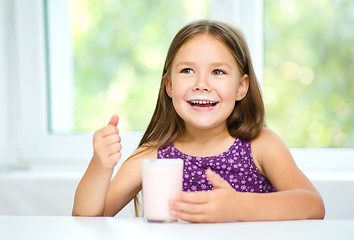 Image showing Cute little girl with a glass of milk