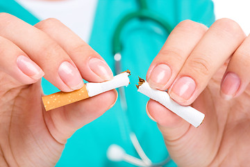 Image showing Doctor in uniform breaks cigarette