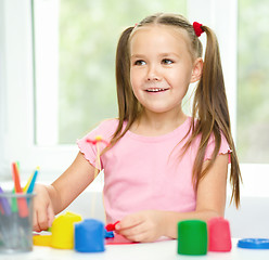 Image showing Girl is having fun while playing with plasticine