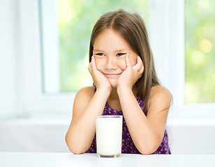 Image showing Cute little girl with a glass of milk