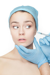 Image showing Attractive woman at plastic surgery with syringe in her face