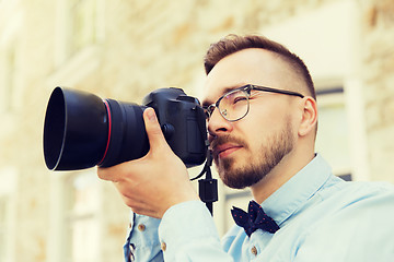 Image showing young hipster man with digital camera in city