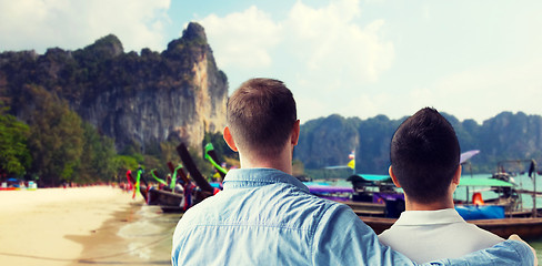 Image showing close up of male gay couple hugging on beach