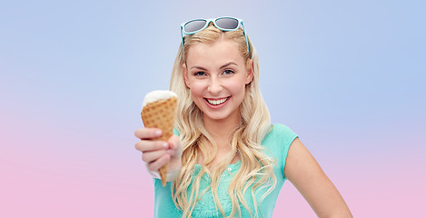 Image showing happy young woman in sunglasses eating ice cream