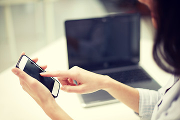 Image showing close up of woman texting on smartphone at office