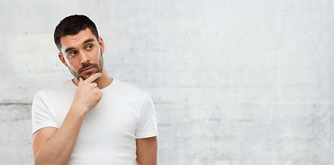Image showing man thinking over gray wall background