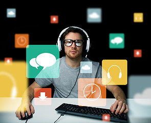 Image showing man in headset with computer and icons on screen