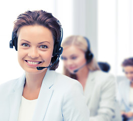 Image showing female helpline operator with headphones