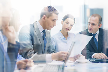 Image showing business team with laptop having discussion