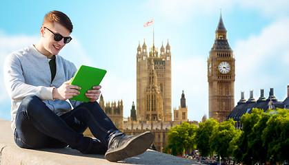 Image showing happy young man with tablet pc over london city