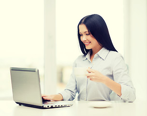 Image showing smiling businesswoman or student with laptop