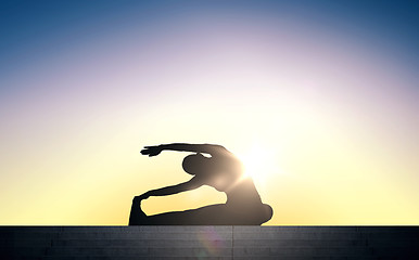 Image showing woman doing exercises on stairs over sun light