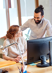 Image showing happy creative team with computer in office