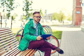 Image showing happy young hipster man with tablet pc and bike