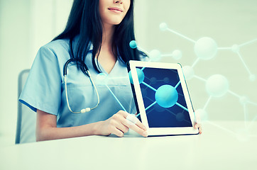 Image showing close up of doctor showing molecules on tablet pc