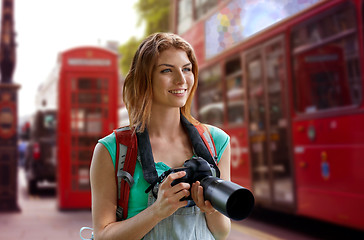 Image showing woman with backpack and camera over london city