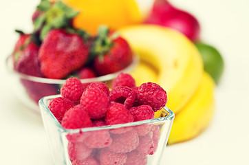 Image showing close up of fresh raspberry and fruits on table