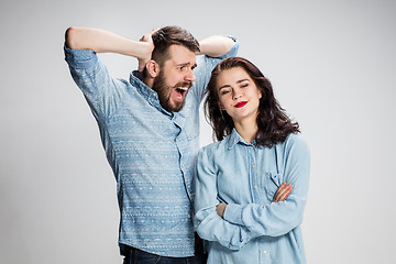 Image showing The young couple with different emotions during conflict