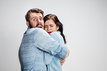 Image showing Emotional facial expression wide eyed couple, woman an man looking surprised open mouth