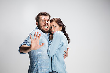 Image showing Emotional facial expression wide eyed couple, woman an man looking surprised open mouth
