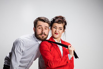 Image showing The business man and woman cooperating on a gray background