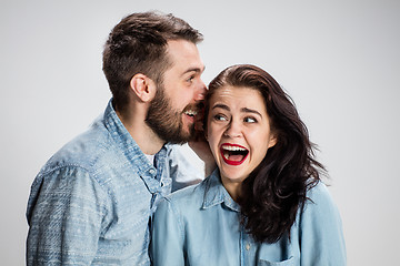 Image showing Young man whispering to woman a secret