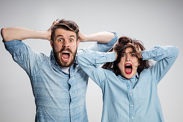 Image showing Close up photo of angry man and woman touching their heads