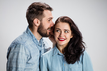 Image showing Young man whispering to woman a secret