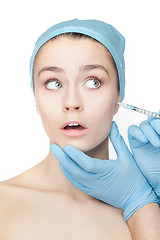 Image showing Attractive woman at plastic surgery with syringe in her face