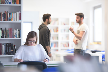 Image showing female student study in school library, group of students in bac