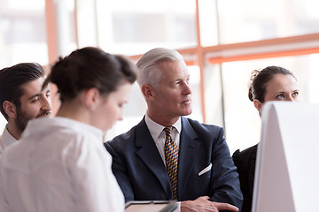 Image showing young startup businessman making presentation to senior investio