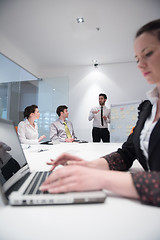 Image showing young business woman on meeting  using laptop computer