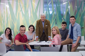 Image showing portrait of  teacher with students group in background