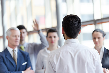 Image showing young startup businessman making presentation to senior investio