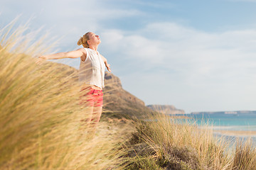 Image showing Free Happy Woman Enjoying Sun on Vacations.