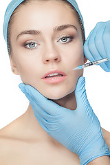 Image showing Attractive woman at plastic surgery with syringe in her face