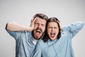 Image showing Close up photo of angry man and woman touching their heads