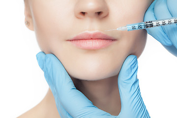 Image showing Attractive woman at plastic surgery with syringe in her face