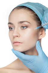 Image showing Attractive woman at plastic surgery with syringe in her face