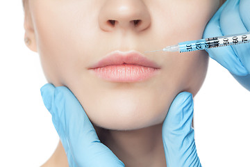 Image showing Attractive woman at plastic surgery with syringe in her face